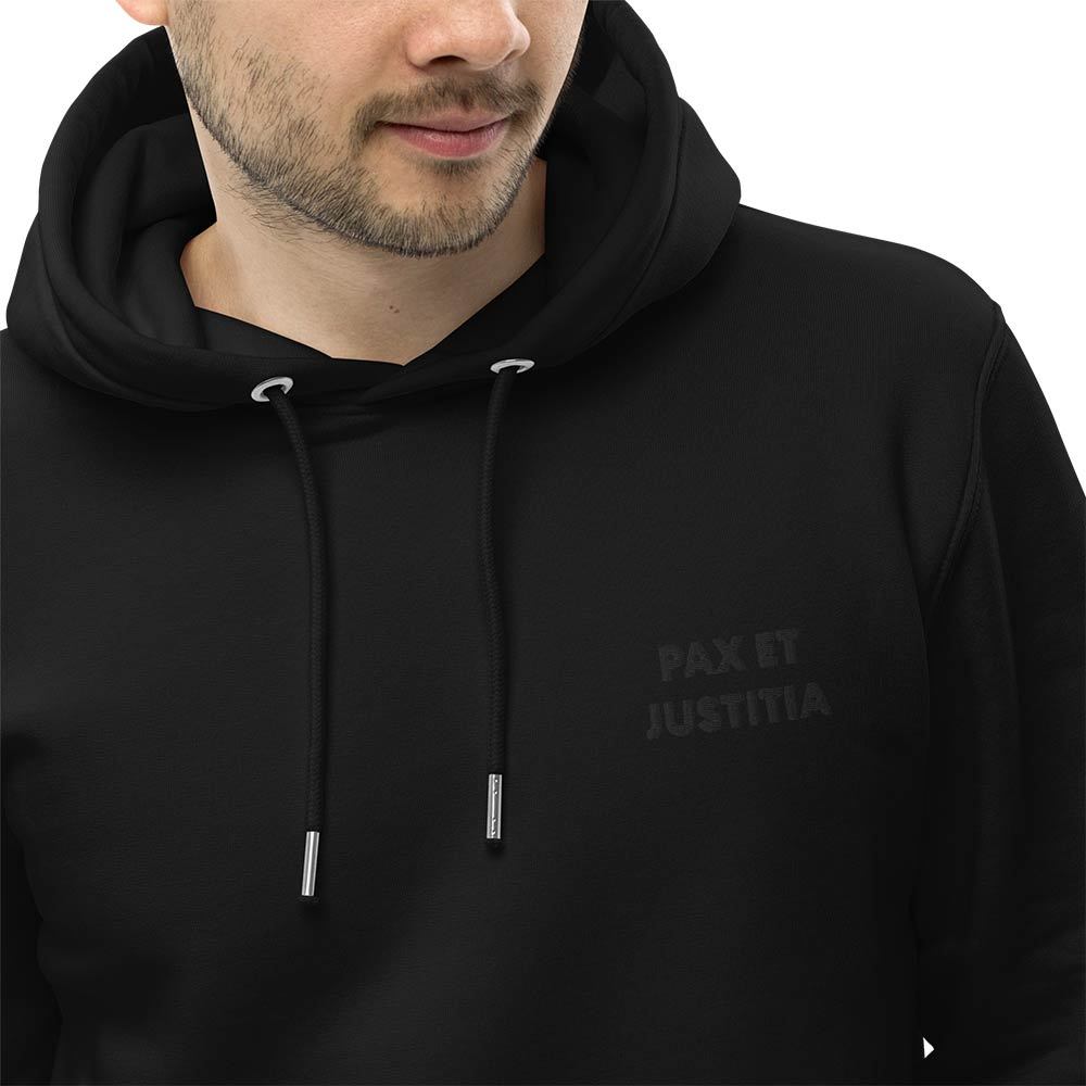 All-Black Minimalist Hoodie "Pax et Justitia". Close-up of a black embroidered motto "Pax et Justitia" on the left front.