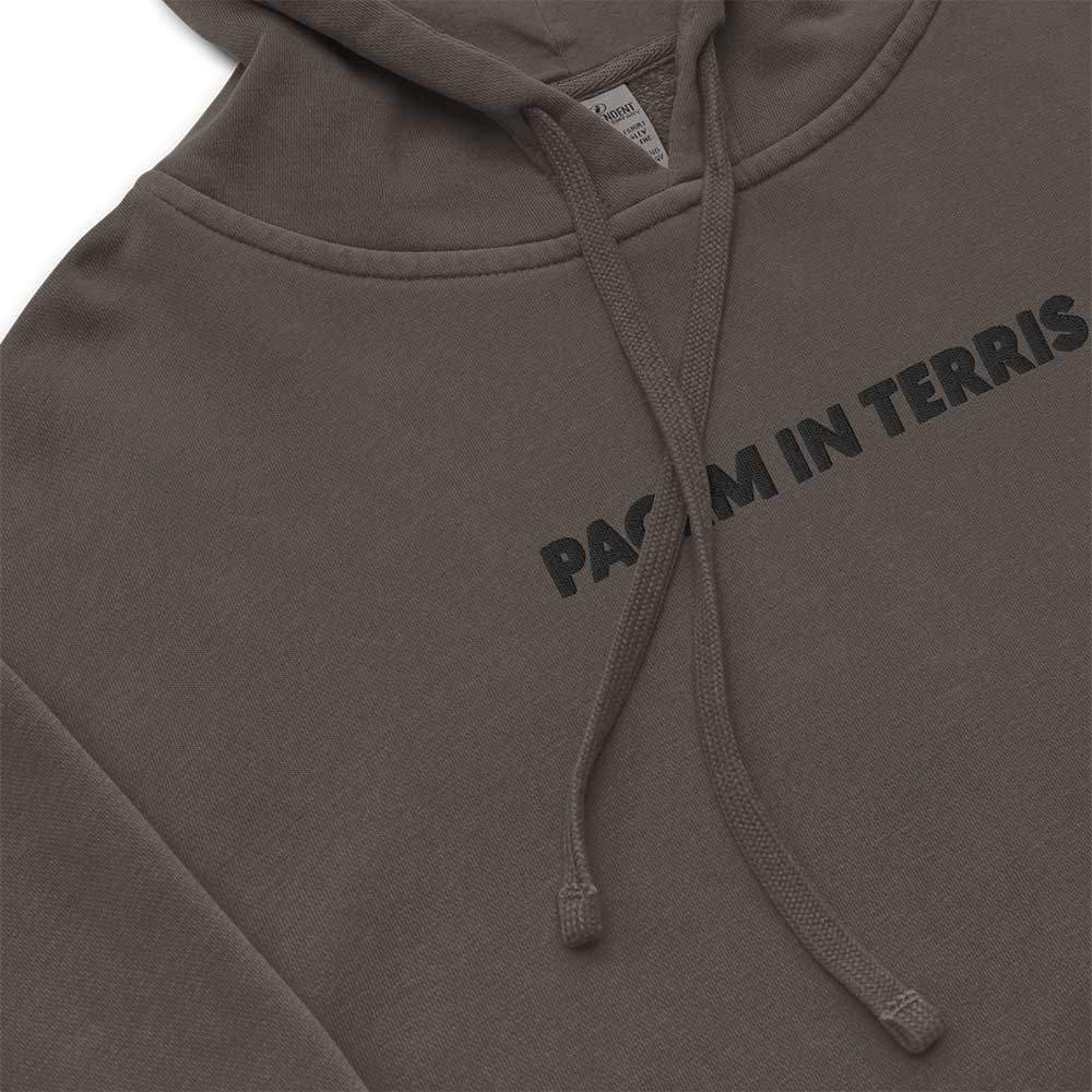 Unisex Vintage Wash Hoodie in Carbon Grey "Pacem in Terris". Close-up of a black embroidered motto "Pacem in Terris" on a center chest.